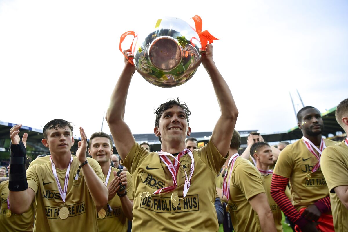 Gustav Wikheim and his FC Midtjylland teammates lifted the Denmark Superliga championship trophy in May 2018 but might play rest of this season at empty arenas with fans in the parking lot watching on video boards.