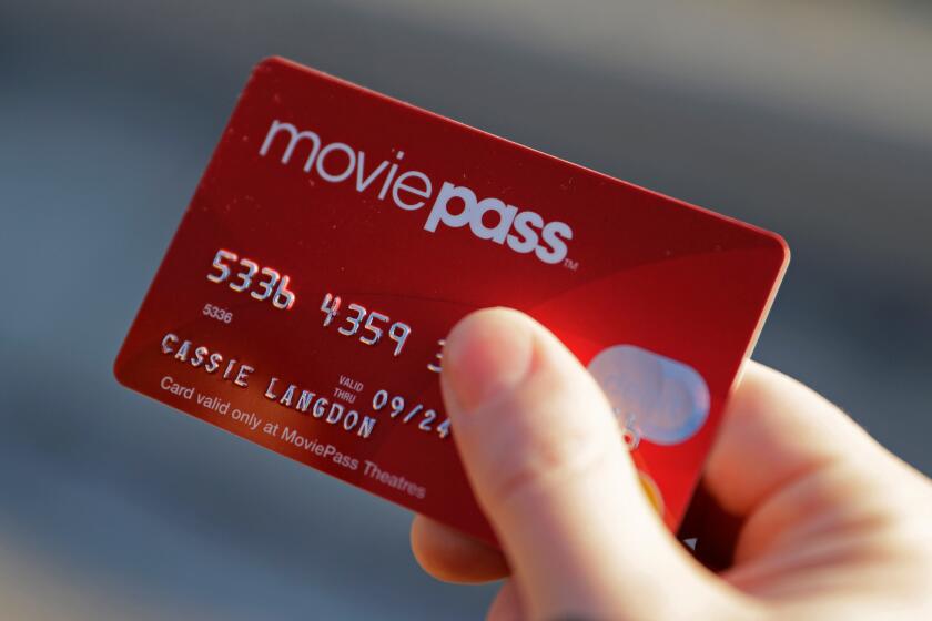 A thumb holding a red transaction card with silver numbers, a name and a big MovePass logo