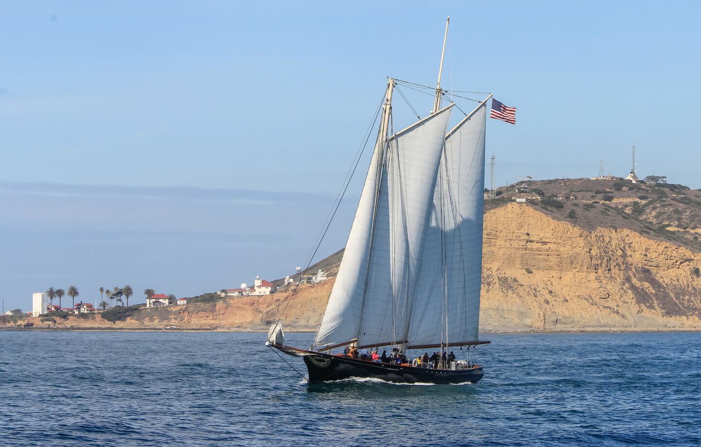 With Point Loma in the background, the yacht America leaves San Diego bay on a sailing tour.