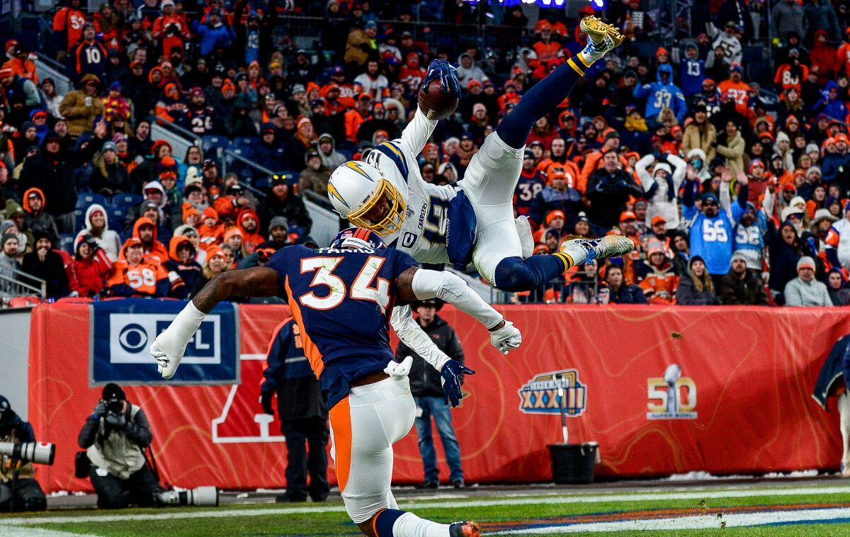 Chargers wide receiver Keenan Allen leaps over Denver Broncos safety Will Parks.