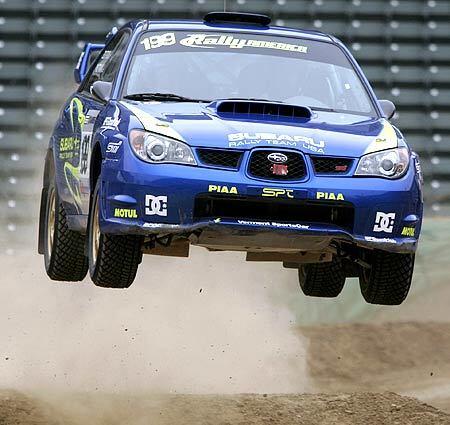 Travis Pastrana and co-driver Christian Edstrom get air on a jump during practice for the X Games Rally Car racing at the Home Depot Center in Carson .