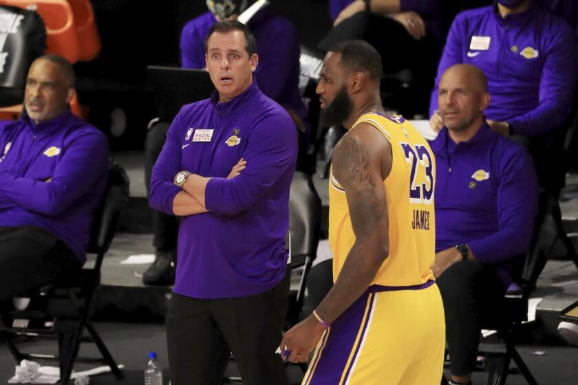 Los Angeles Lakers coach Frank Vogel talks with LeBron James during the fourth quarter of the team's NBA basketball game against the Los Angeles Clippers on Thursday, July 30, 2020, in Lake Buena Vista, Fla. (Mike Ehrmann/Pool Photo via AP)