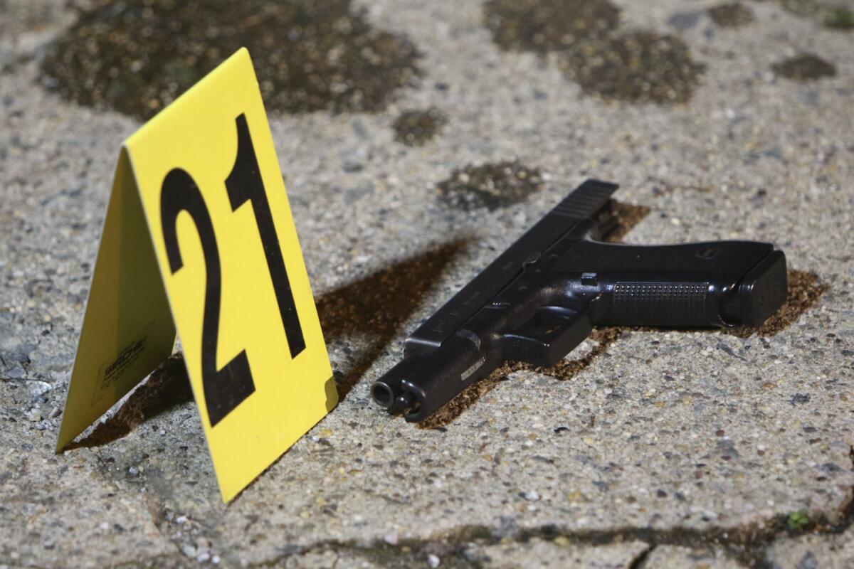 Evidence is marked at the scene in Philadelphia where a gunman attacked a police officer.