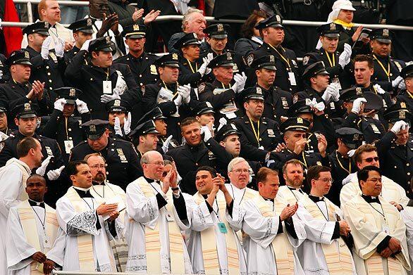 Thousands gather at Yankee Stadium for Mass led by Pope Benedict XVI on Sunday. A group claps during the pre-show for the pope 's visit.