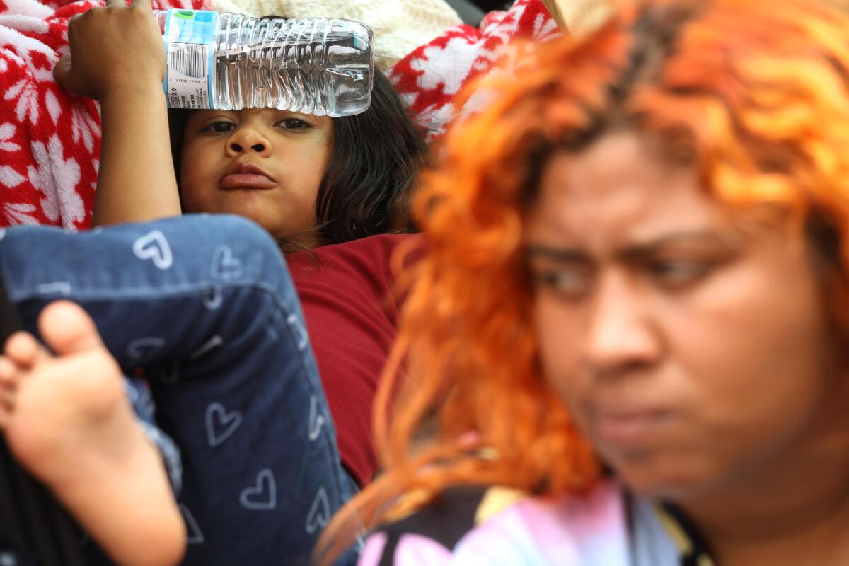 Jaidelin Chacon, right, sits next to her daughter Celeste, 5, who 