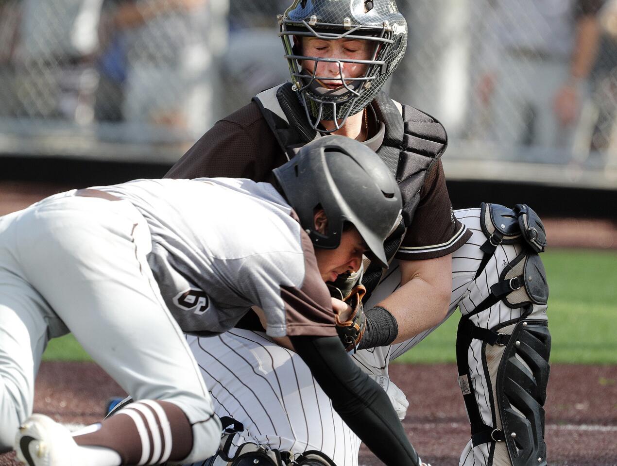 St. Francis' catcher Brendan Durfee prepares for Crespi's Parker Smith to drive hard into him to attempt to knock the ball free to score in a Mission League baseball game at the Glendale Sports Complex on Wednesday, March 27, 2019. Durfee held on, and Smith was out.