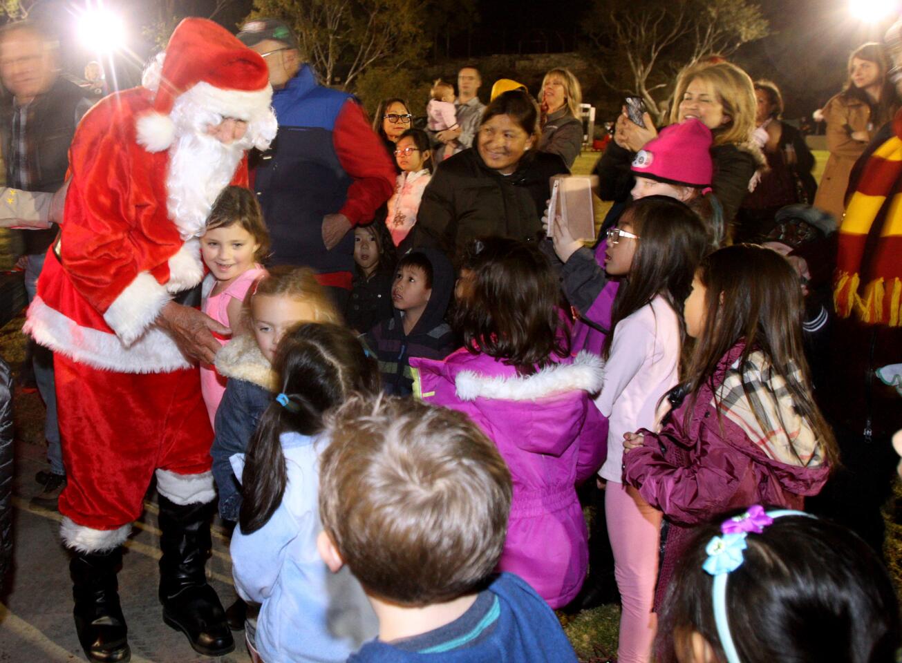 Santa Claus is greeted by young children as he arrived at the 21st Festival in Lights at Memorial Park in La Cañada Flintridge on Friday, Dec. 4, 2015.