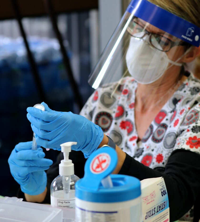 Karen L. Simerlink, RN, will prepare the COVID-19 vaccine at the Central Net Training Center in Huntington Beach on Wednesday.
