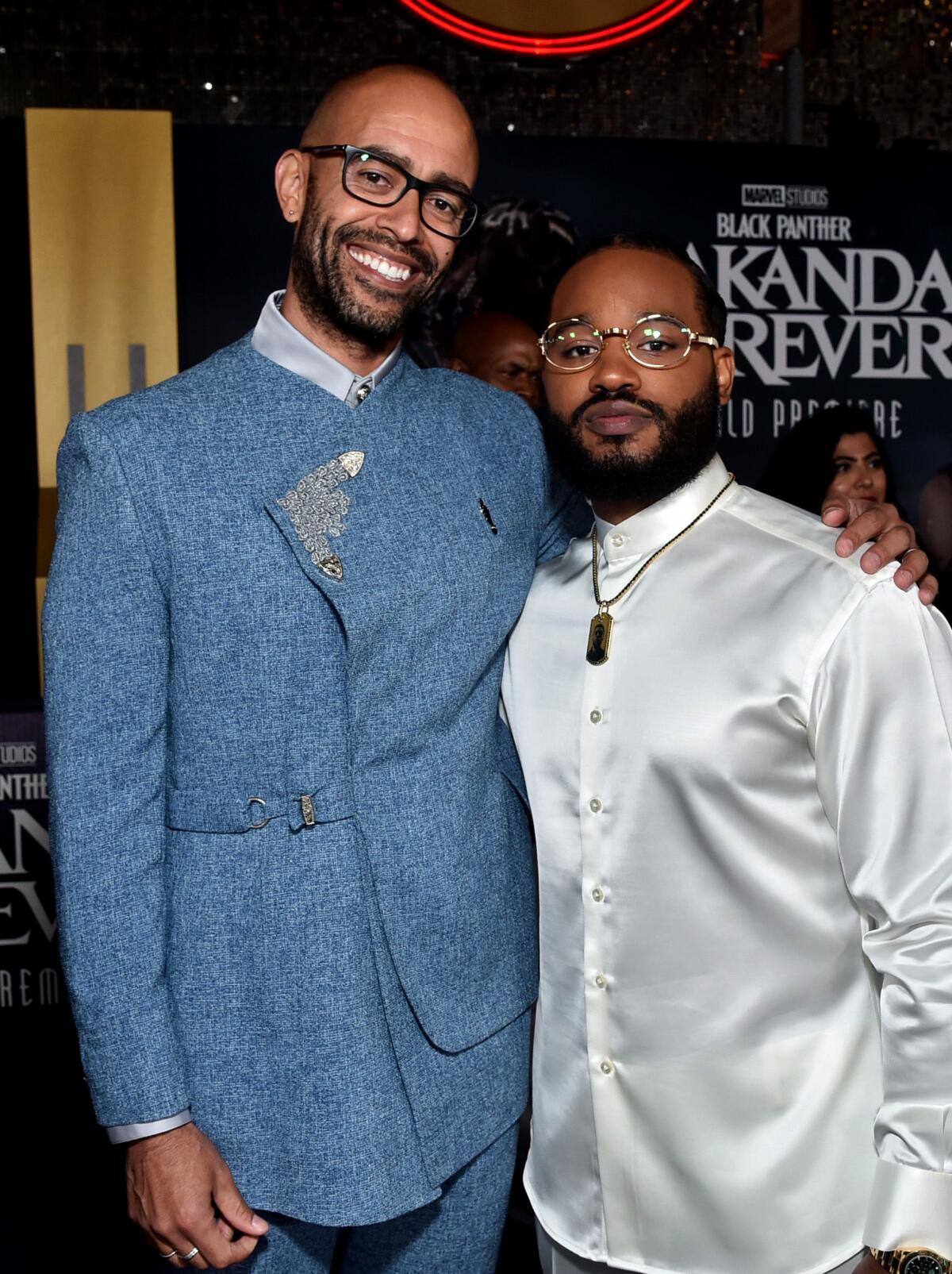 Two men pose for a photo at the world premiere of "Black Panther: Wakanda Forever."