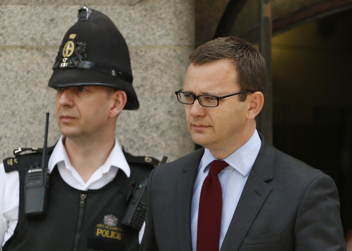 Former tabloid editor Andy Coulson leaves the Old Bailey courthouse in London on Wednesday after jurors in Britain's phone-hacking trial deadlocked on whether Coulson and a former reporter bribed someone on the royal family's security detail for a phone directory of the royal household.