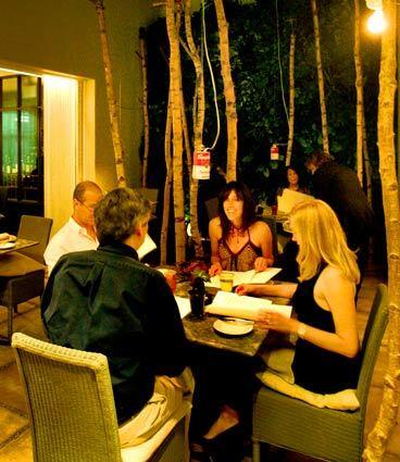 Art objects hang from tree trunks in one of the petite dining rooms of Bastide restaurant, which is open for dinner in West Hollywood. Bastide, known for its elegant food and wine, recently hired a new chef and now offers an a la carte menu in addition to its chef's tasting menu.