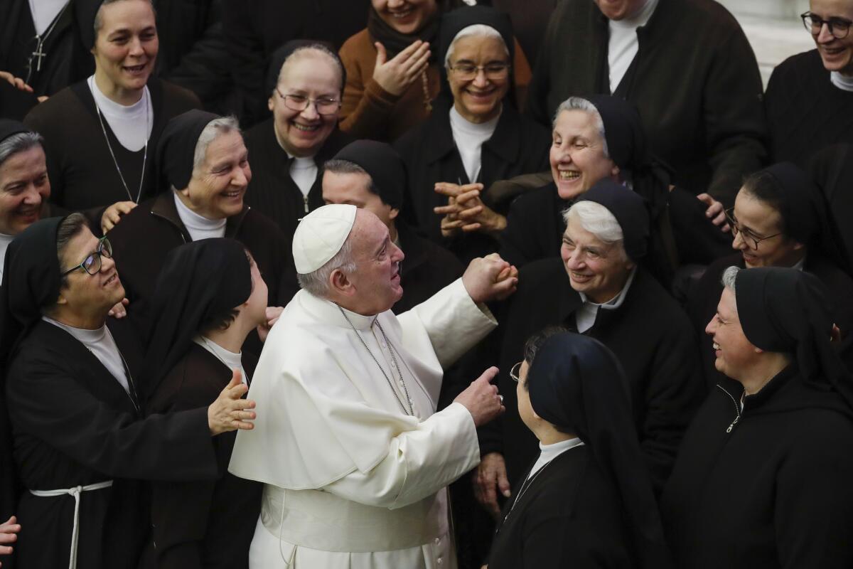 Pope Francis greets a group of nuns during his weekly general audience, in Paul VI Hall at the Vatican, on Wednesday.