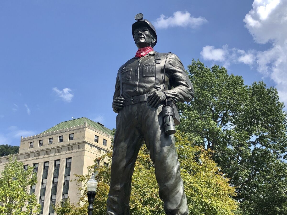 A statue of a coal miner is shown Thursday, Aug. 26, 2021, at the West Virginia Capitol in Charleston, W.Va. This weekend, marchers are retracing the steps of thousands of coal miners who participated in the Battle of Blair Mountain in southern West Virginia. At least 16 men died in the largest U.S. armed uprising since the Civil Warbefore the miners surrendered to federal troops in early September 1921. (AP Photo/John Raby)