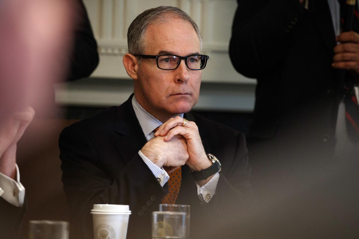 Former Environmental Protection Agency administrator Scott Pruitt listens as President Donald Trump speaks during a cabinet meeting.