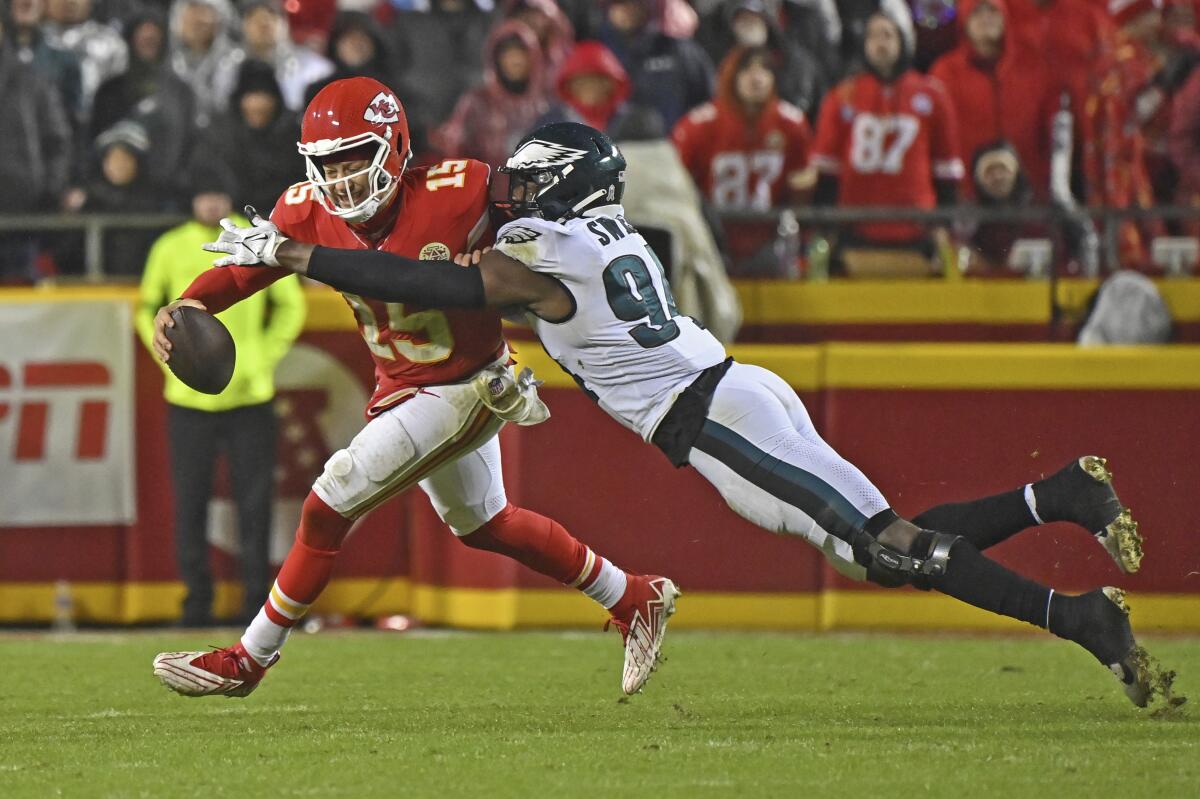 Eagles defensive end Josh Sweat tackles Chiefs quarterback Patrick Mahomes Monday in Kansas City, Mo. 