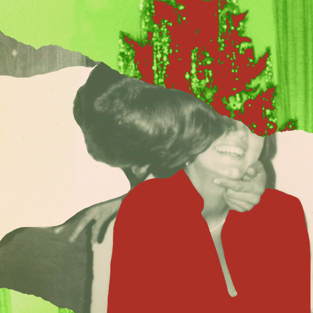 A man and woman embrace under a Christmas tree 