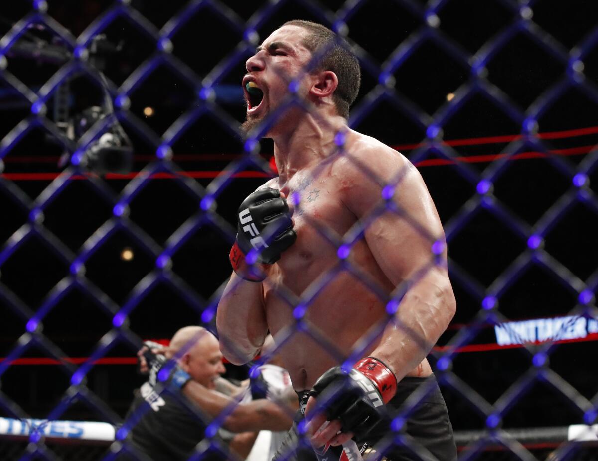 Robert Whittaker celebrates after defeating Yoel Romero at UFC 225 in June 2018.
