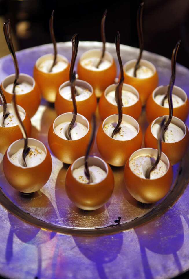 Chocolate mousse in golden egg cups.