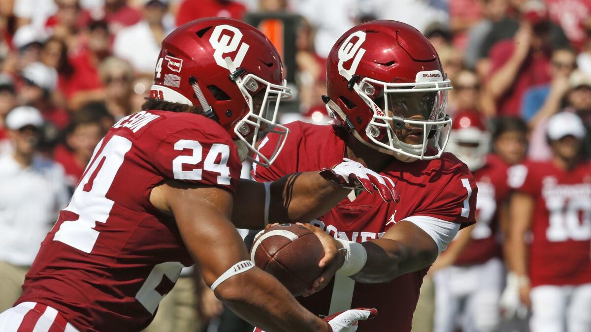 Oklahoma quarterback Kyler Murray (1) hands off to running back Rodney Anderson (24) in the first half against Florida Atlantic in Norman, Okla. on Saturday.