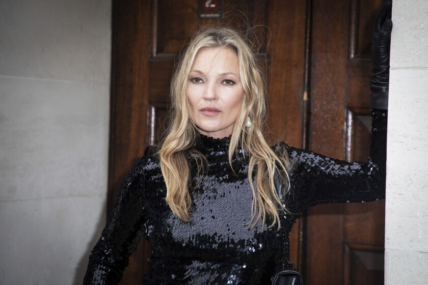 Kate Moss poses for photographers upon arrival at the Burberry fashion collection, unveiled in London, Friday, March 11, 2022. (Photo by Vianney Le Caer/Invision/AP)