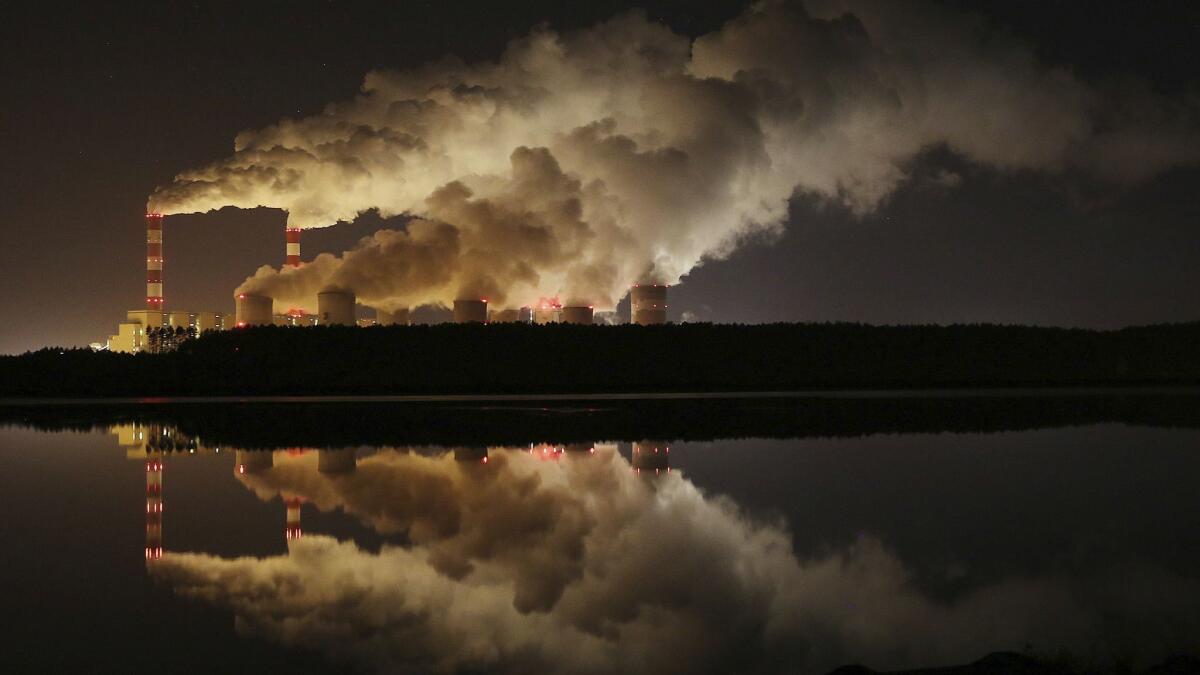 Plumes of smoke and steam rise from Europe's largest lignite power plant in Belchatow, Poland, on Nov. 28.