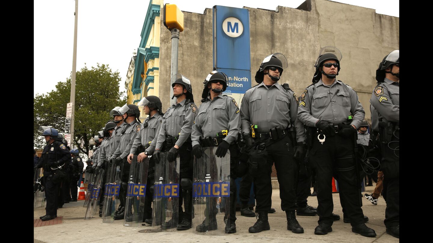Police gather at a CVS corner in Baltimore.