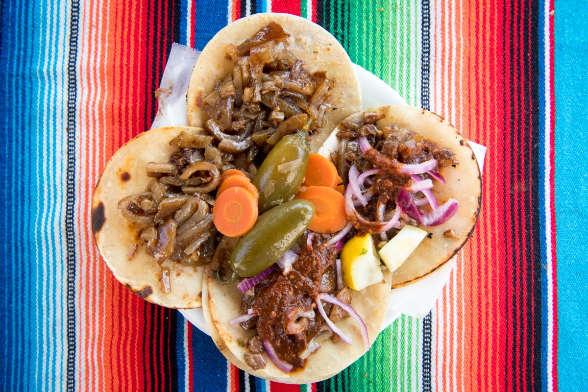 Cueritos and mixo tacos at Carnitas El Momo. The Acosta family suggests trying its carnitas garnished only with pickled vegetables.