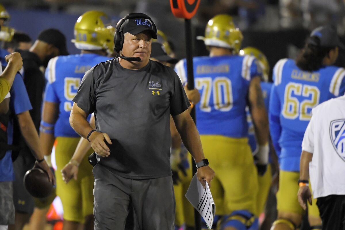 UCLA coach Chip Kelly stands on the sideline.