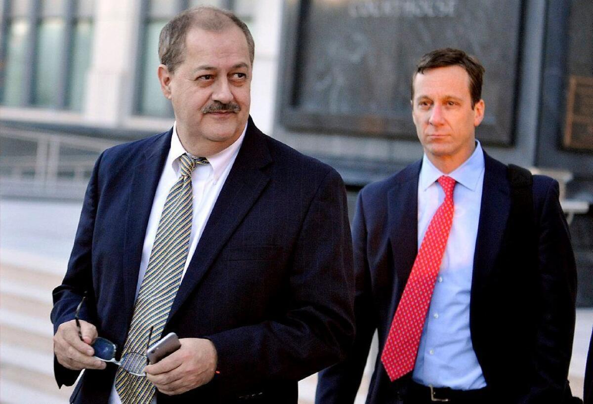 Don Blankenship, left, leaves a federal courthouse in West Virginia with his lawyer in 2015, as a jury pondered his guilt in a mine disaster. He was convicted on a single misdemeanor count and served a year.