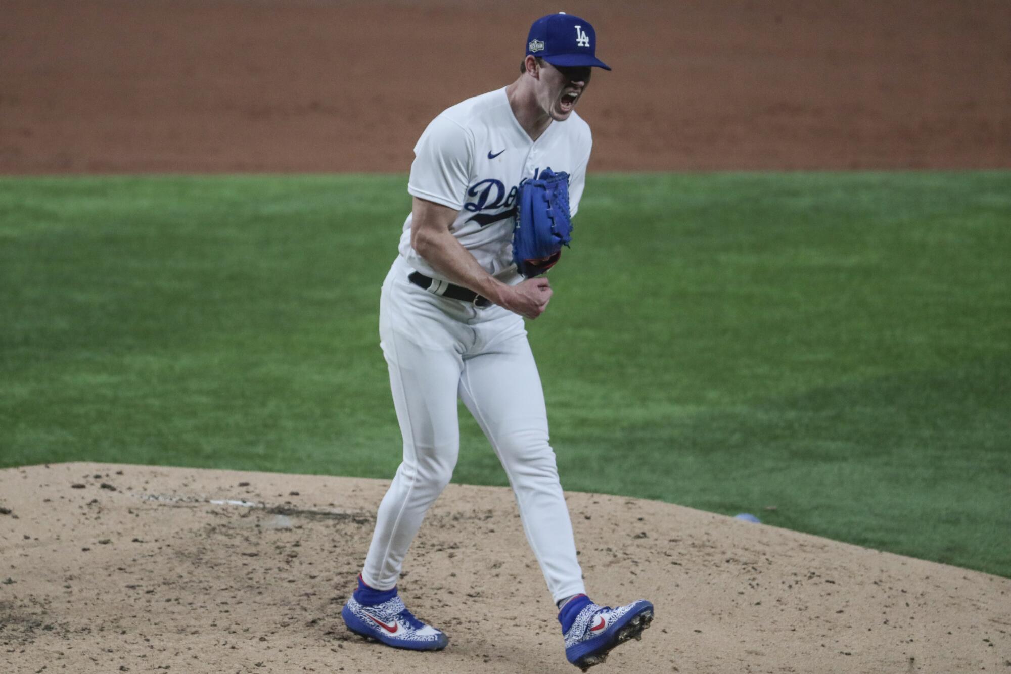 Dodgers starting pitcher Walker Buehler shouts after striking out San Diego Padres center fielder Trent Grisham.