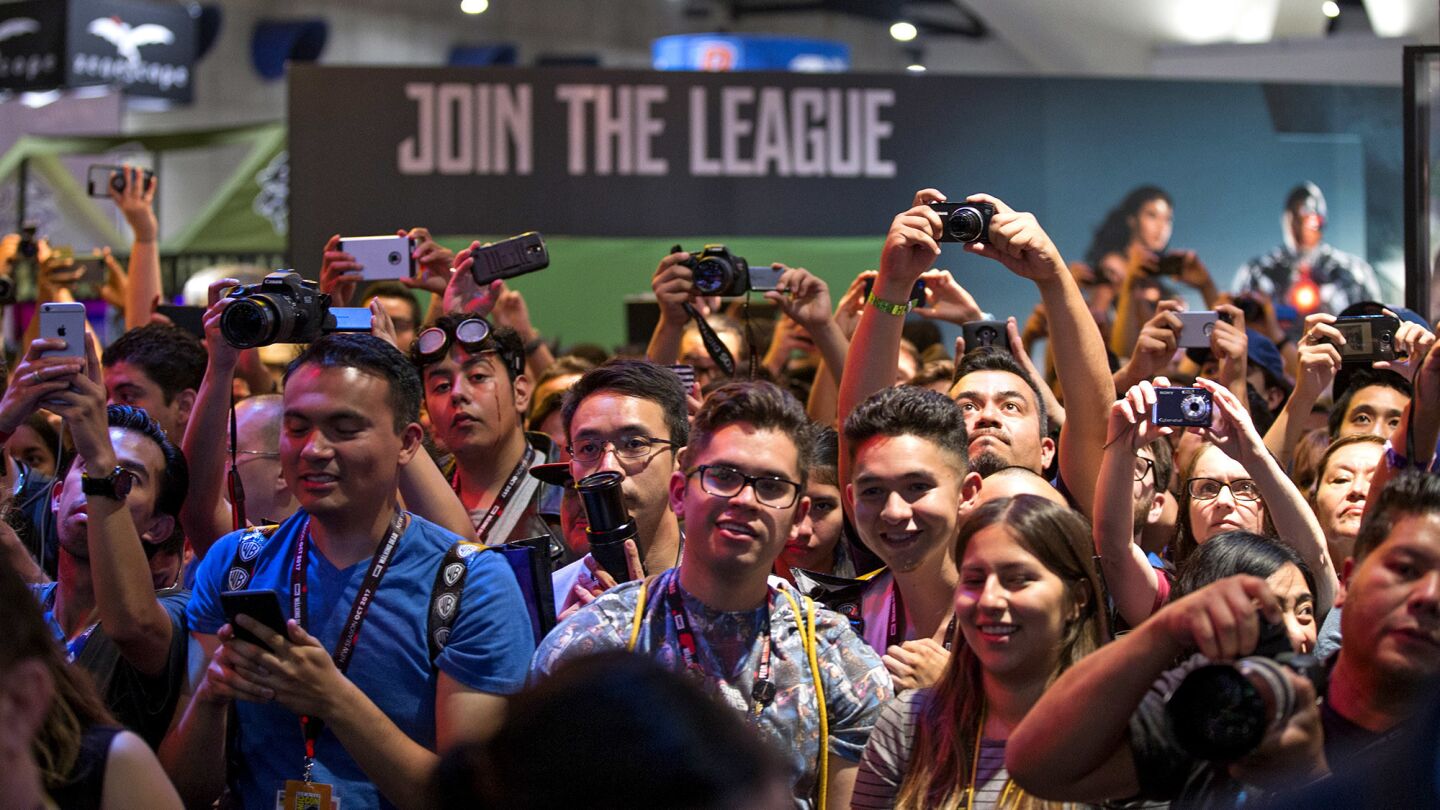 Fans pack together Saturday as the cast of "Justice League" -- Ray Fisher as Cyborg, Ezra Miller as Flash, Gal Gadot as Wonder Woman, Jason Momoa as Aquaman and Ben Affleck as Batman -- appears at the DC Comics booth at Comic-Con 2017.