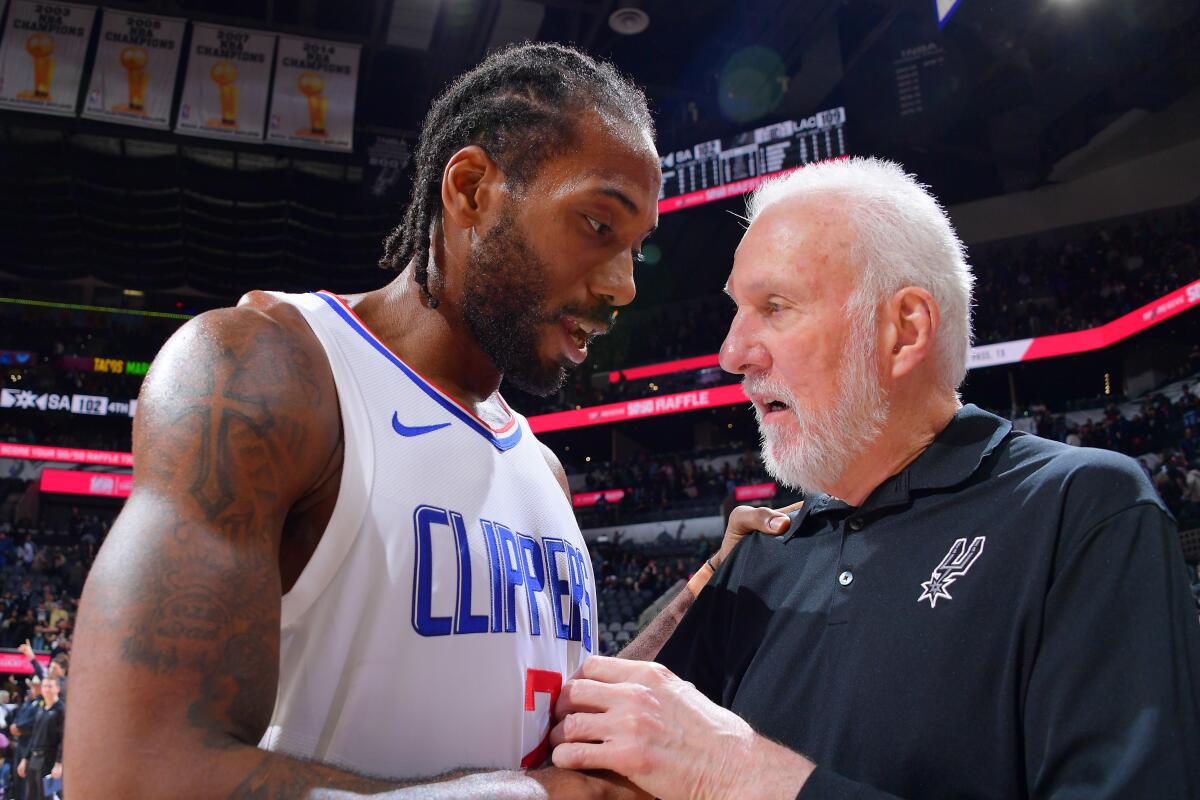 The Clippers' Kawhi Leonard talks with Spurs coach Gregg Popovich, who previously coached Leonard in San Antonio