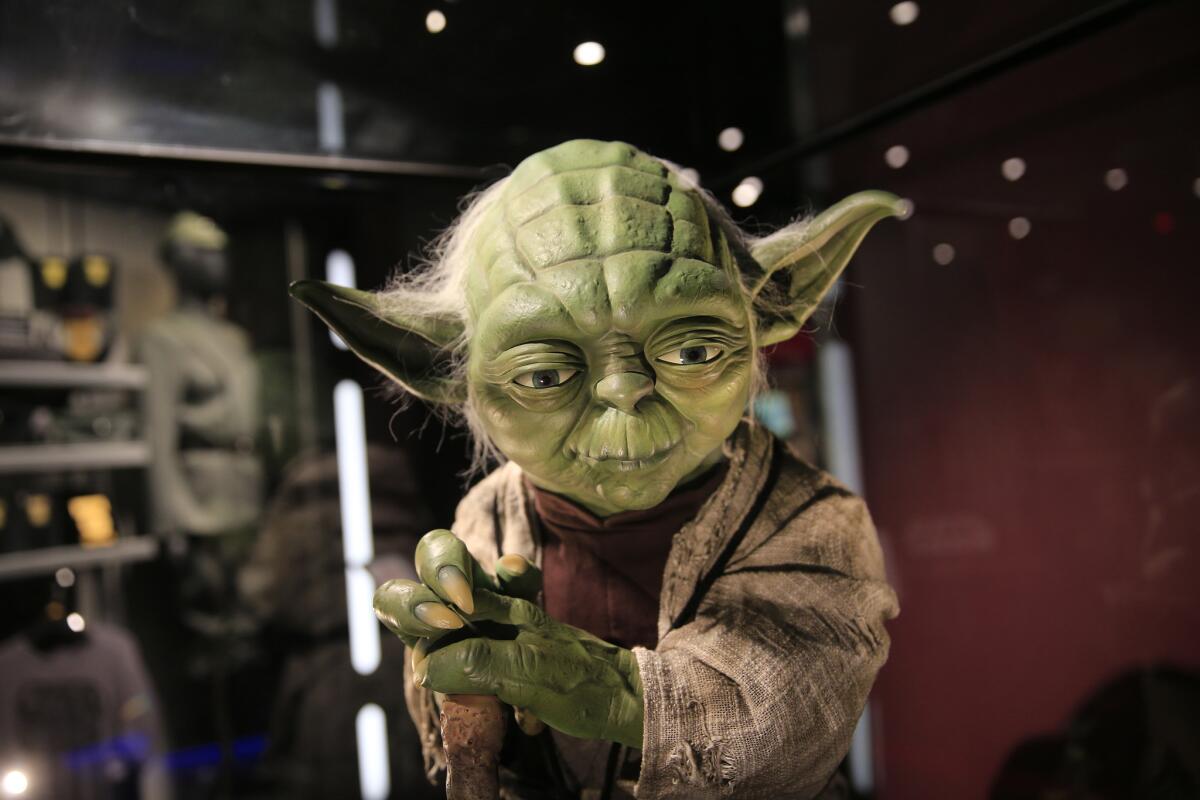 A $3,000 life-size Yoda from "Star Wars" is on display inside the Launch Bay gift store at Disneyland.