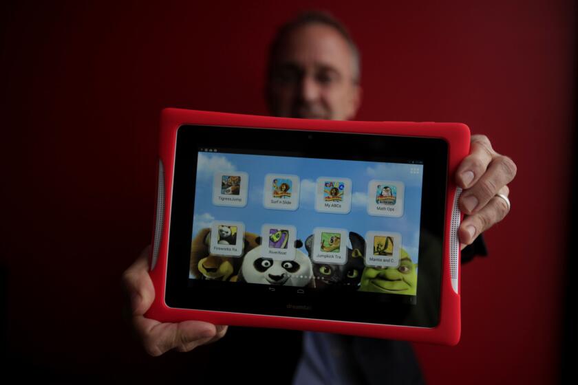 Fuhu Chief Executive Jim Mitchell holds a Nabi tablet.