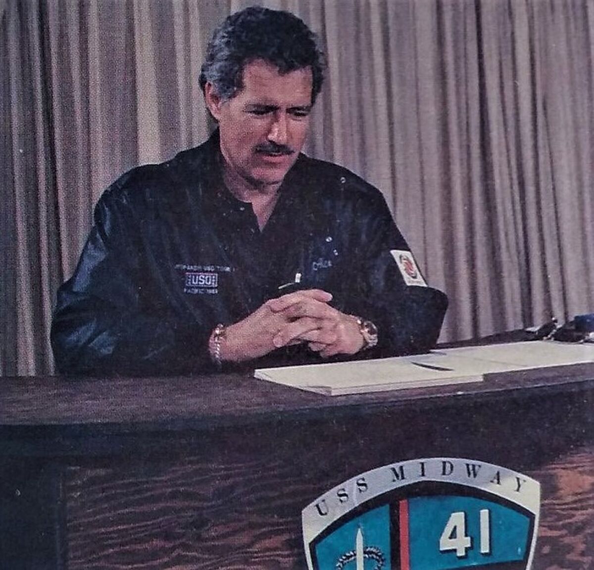 A young Alex Trebek aboard the U.S.S. Midway aircraft carrier while on a USO tour in 1988.