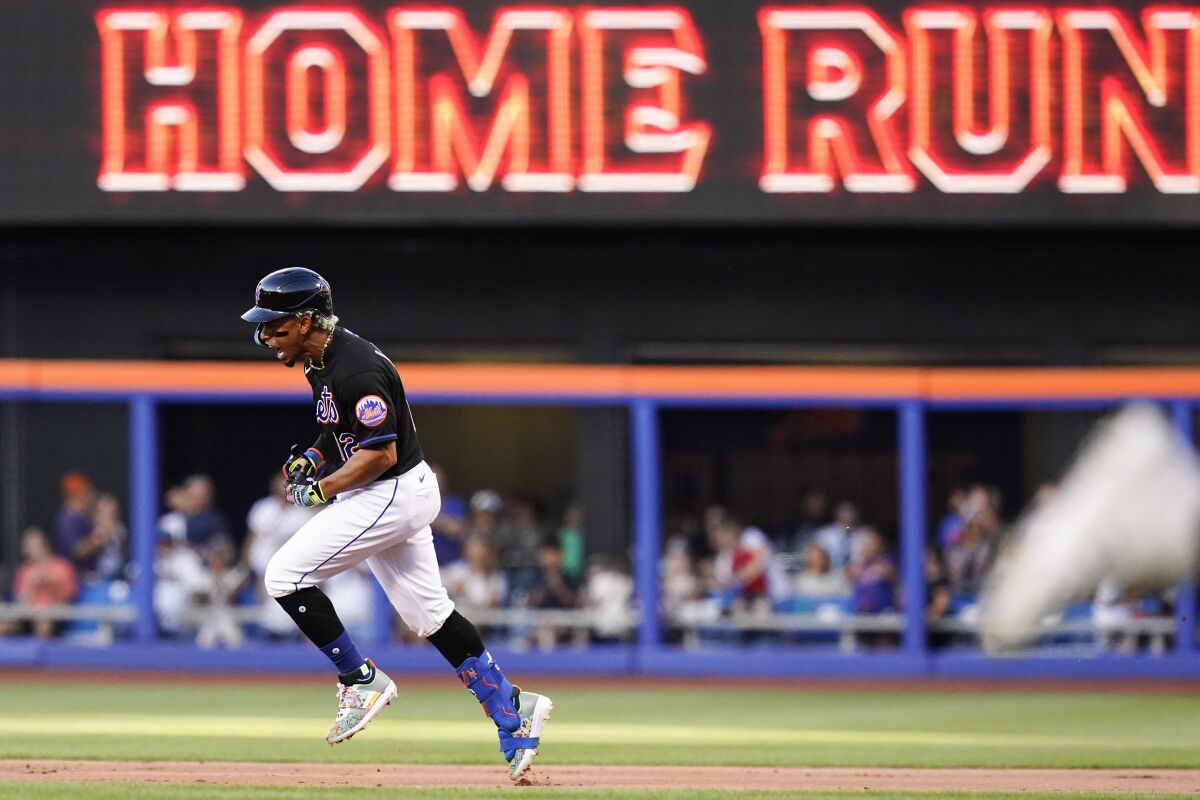 New York Mets' Francisco Lindor celebrates as he runs the bases after hitting a three-run home run during the first inning of a baseball game against the Miami Marlins, Friday, June 17, 2022, in New York. (AP Photo/Frank Franklin II)