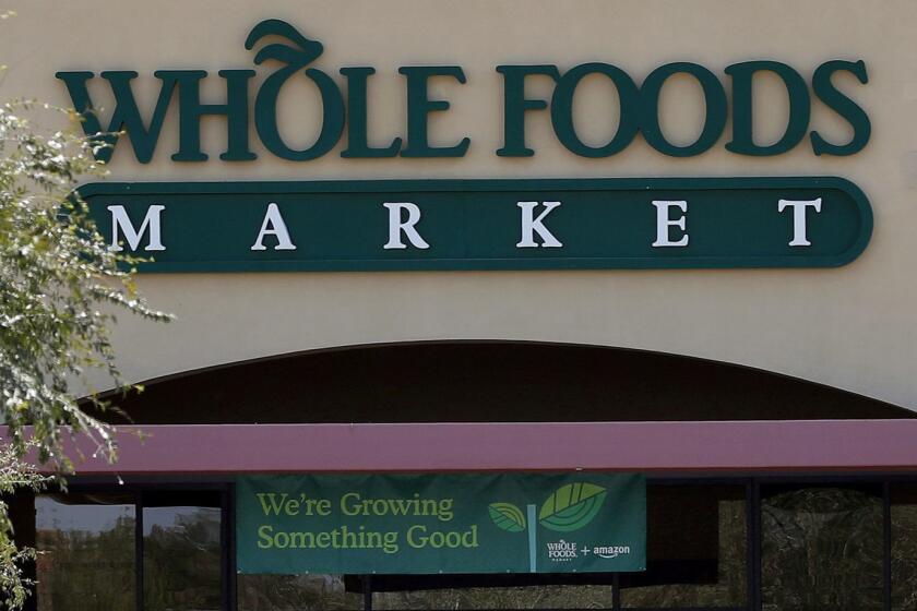 Shoppers come and go from Whole Foods Market grocery store, Monday, Aug. 28, 2017 in Chandler, Ariz. Amazon is moving swiftly to make big changes at Whole Foods, saying it plans to cut prices on avocados, bananas, eggs, salmon, beef and more. Amazon has completed its $13.7 billion takeover of organic grocer Whole Foods, and the e-commerce giant is wasting no time putting its stamp on the company. (AP Photo/Matt York)