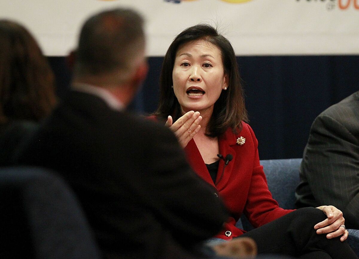 Rep. Michelle Steel gestures while speaking at a panel discussion