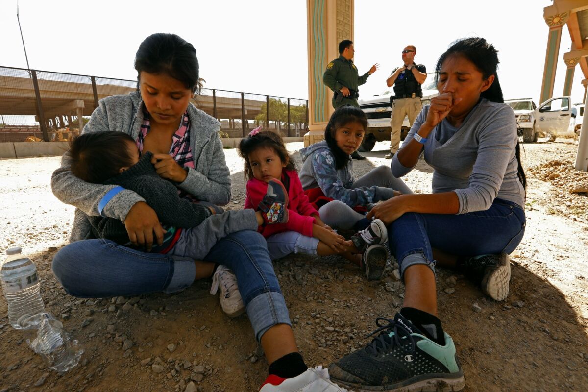 Lucero Gerrald, 22, son Gael Ria and daughter Ilene Aquemi sit in El Paso with Darlene Perez, 32, and her daughter Natalie Jimena. On Sunday, volunteers in El Paso tried to deliver diapers and other goods for the Clint facility, but were turned away.