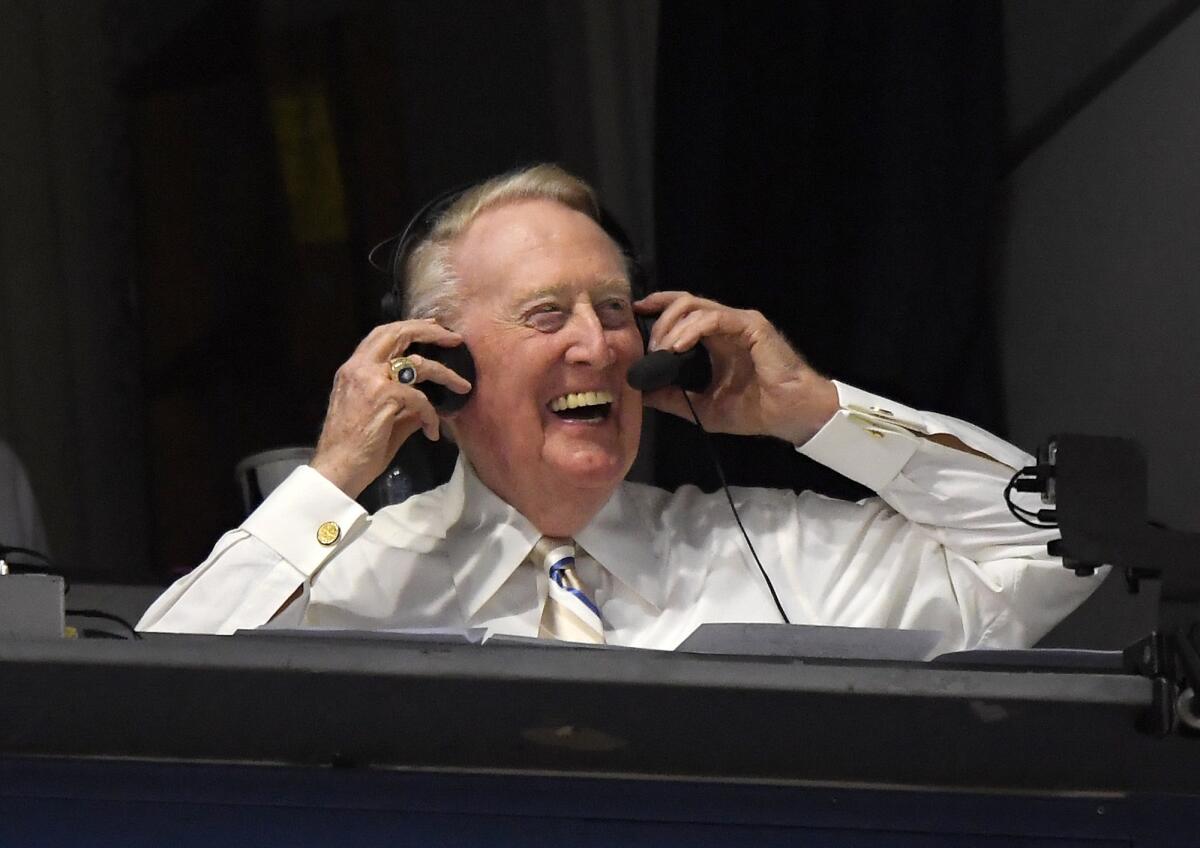 Los Angeles Dodgers' Hall of Fame announcer Vin Scully puts his headset on prior to a baseball game between the Dodgers and the San Francisco Giants in Los Angeles on Monday, Sept. 19, 2016.