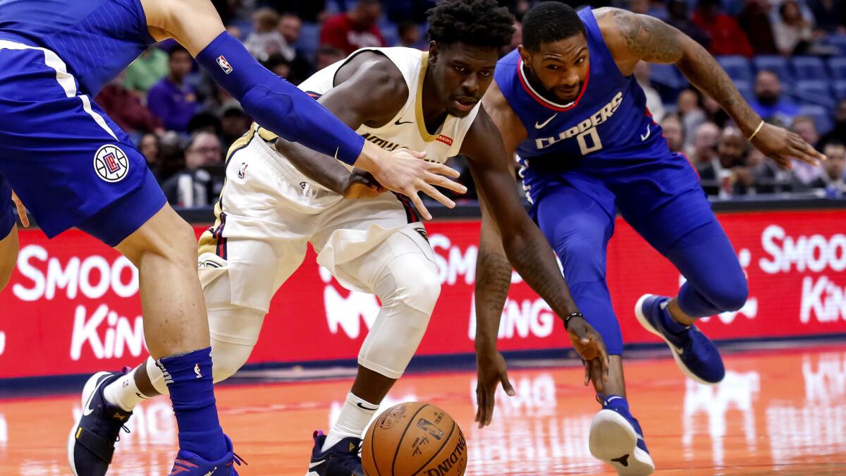 Clippers guard Sindarius Thornwell, right, slaps the ball away from Pelicans guard Jrue Holiday during the first half Saturday.