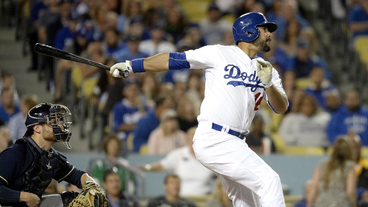 Dodgers pinch-hitter Andre Ethier follows through on a two-run single against the Brewers in the seventh inning Friday night at Dodger Stadium.