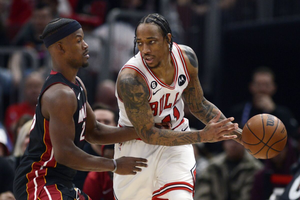 Chicago Bulls' DeMar DeRozan (11) looks to pass against Miami Heat's Jimmy Butler (22) during the second half of an NBA basketball game, Saturday, March 18, 2023, in Chicago. Chicago won 113-99. (AP Photo/Paul Beaty)
