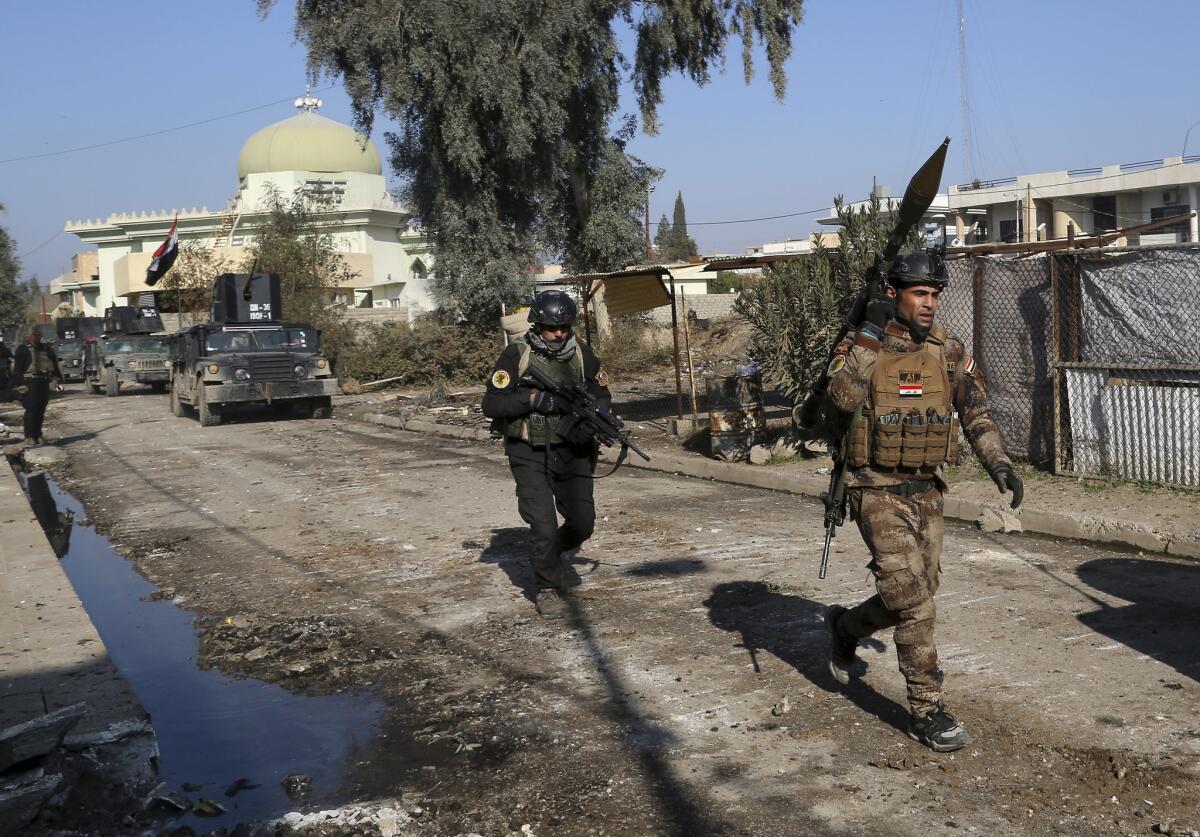 Iraqi special forces troops advance during a battle Jan. 16 against Islamic State militants in Andalus neighborhood in the eastern side of Mosul.