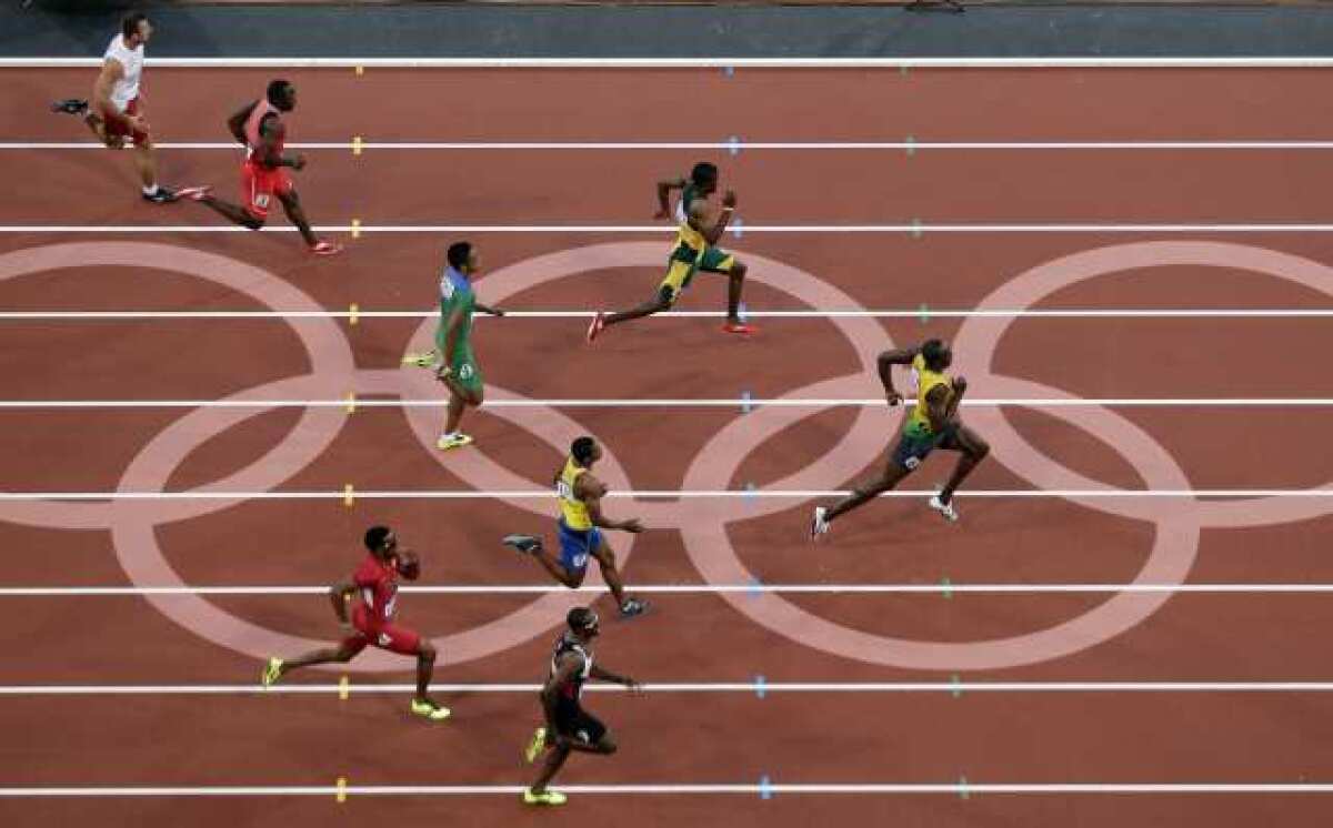 Jamaica's Usain Bolt, right, leads his 200-meter semifinal heat Wednesday.