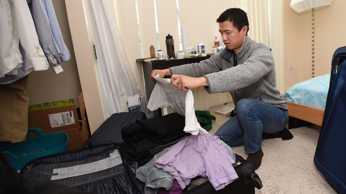 Leo Wang packs his belongings at his home in San Jose on Jan. 31 as he prepares to leave the country.