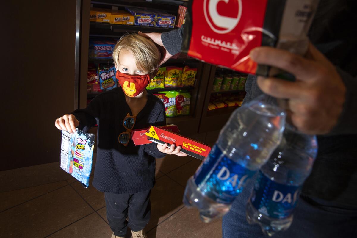 A 4-year-old boy selects items at the Cinemark Playa Vista and XD movie theater on its reopening day.