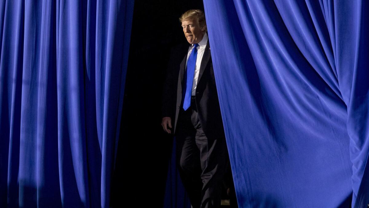 President Donald Trump takes the stage to speak to a Venezuelan American community at Florida Ocean Bank Convocation Center at Florida International University in Miami, Fla., Monday, Feb. 18, 2019. (AP Photo/Andrew Harnik)