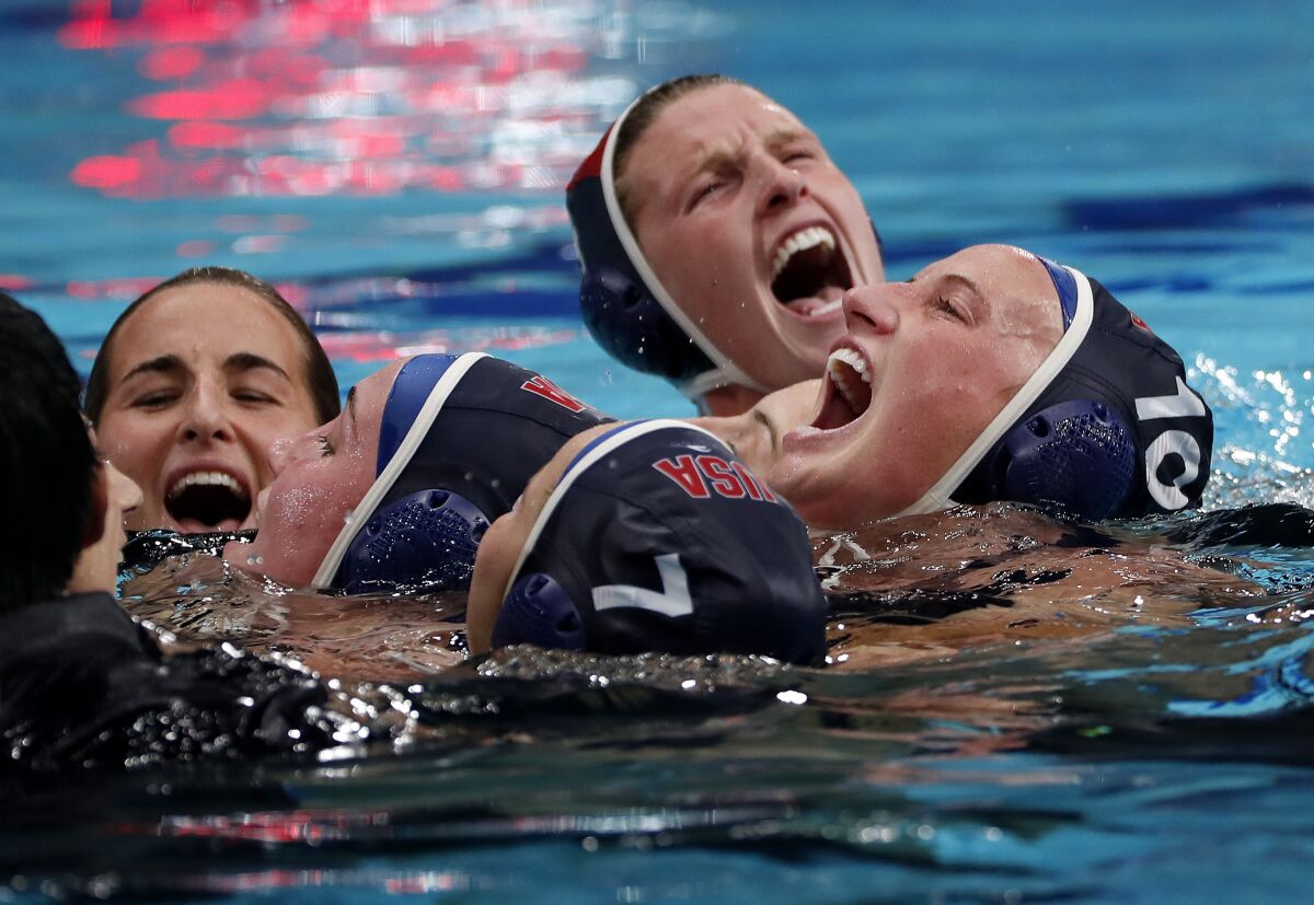 The U.S. women's water polo team shouts with joy.