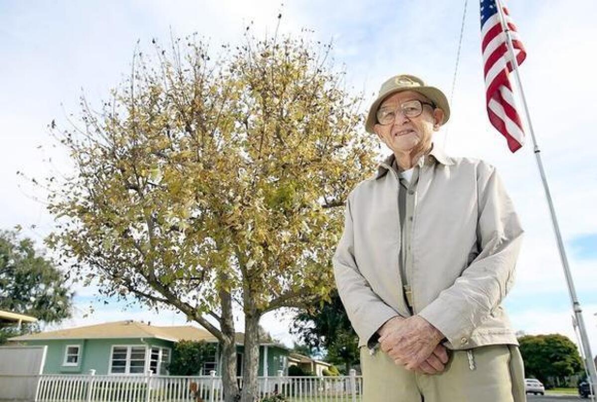 World War II veteran Thomas G. Riker, 95, poses for a portrait at his home in Eastside Costa Mesa.